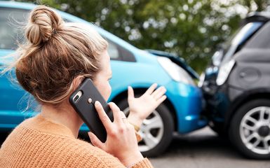 Female Motorist Involved In Car Accident Calling Insurance Company Or Recovery Service