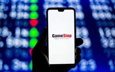 In this photo illustration a GameStop logo is seen displayed